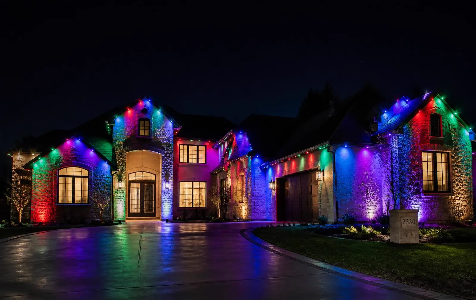 Home lit with color-changing permanent LED roofline lighting