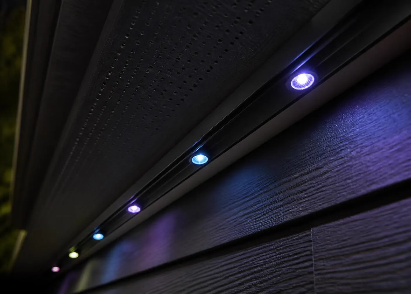 Close-up of discreet color-matched track with recessed RGB permanent lighting pucks
